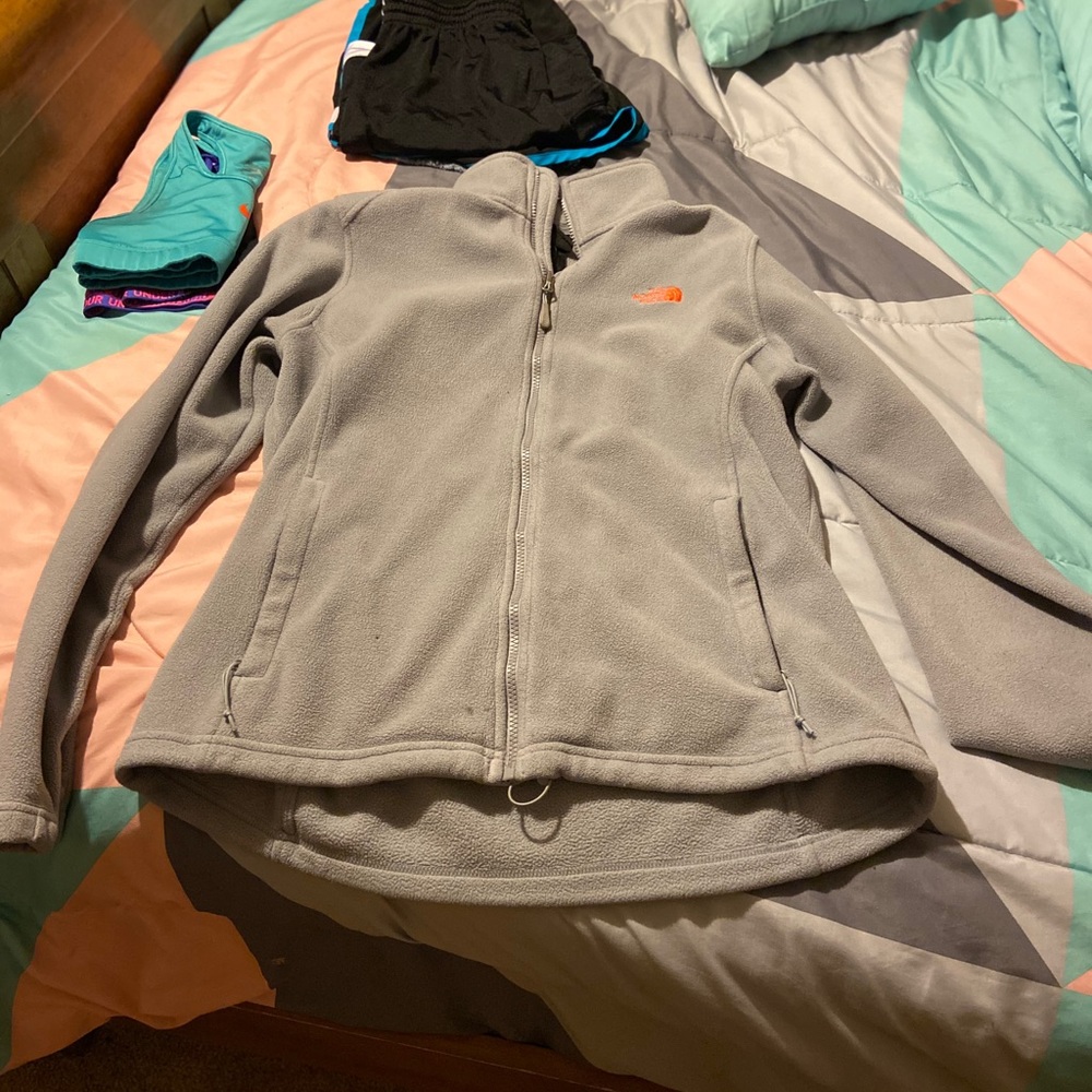 Grey and orange north face zip up jacket